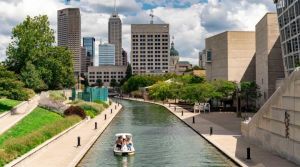 Indianapolis Canal Walk, clouds in the sky, paddle boat in the water near the Indiana State Museum