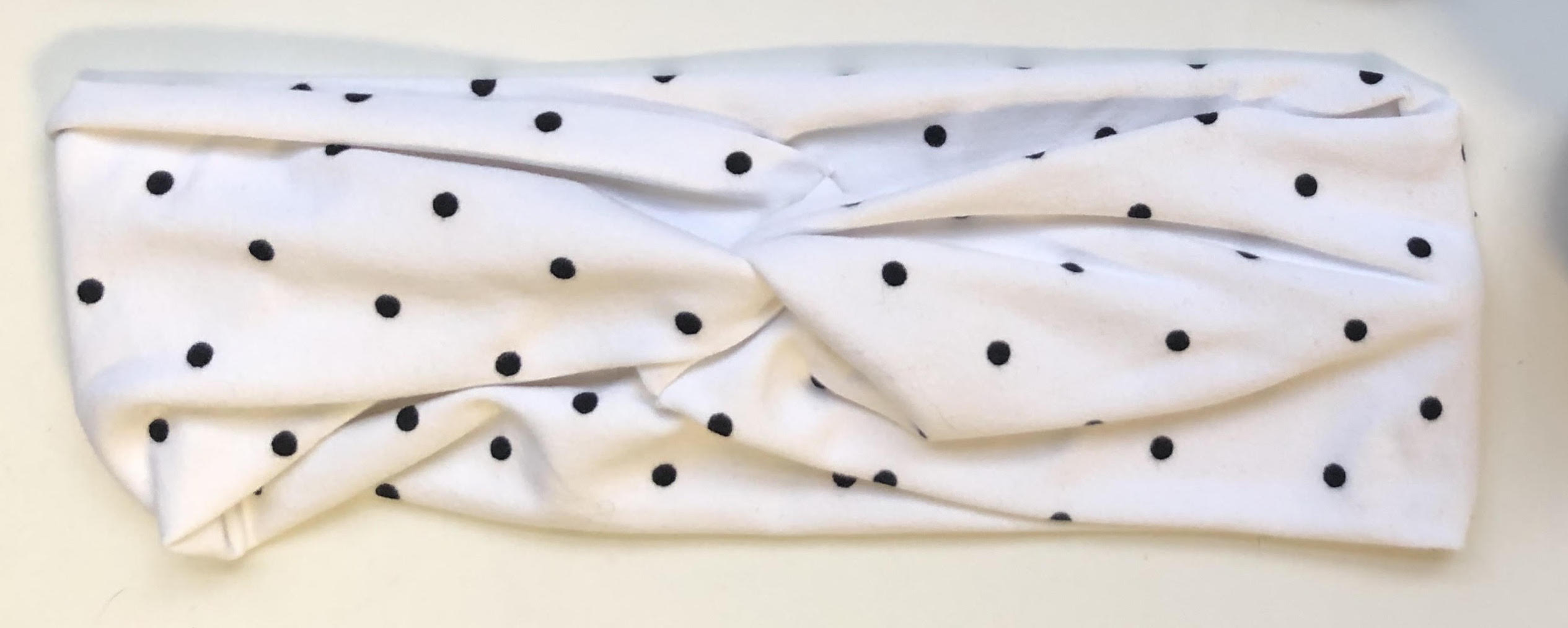 white headband with black polka dots