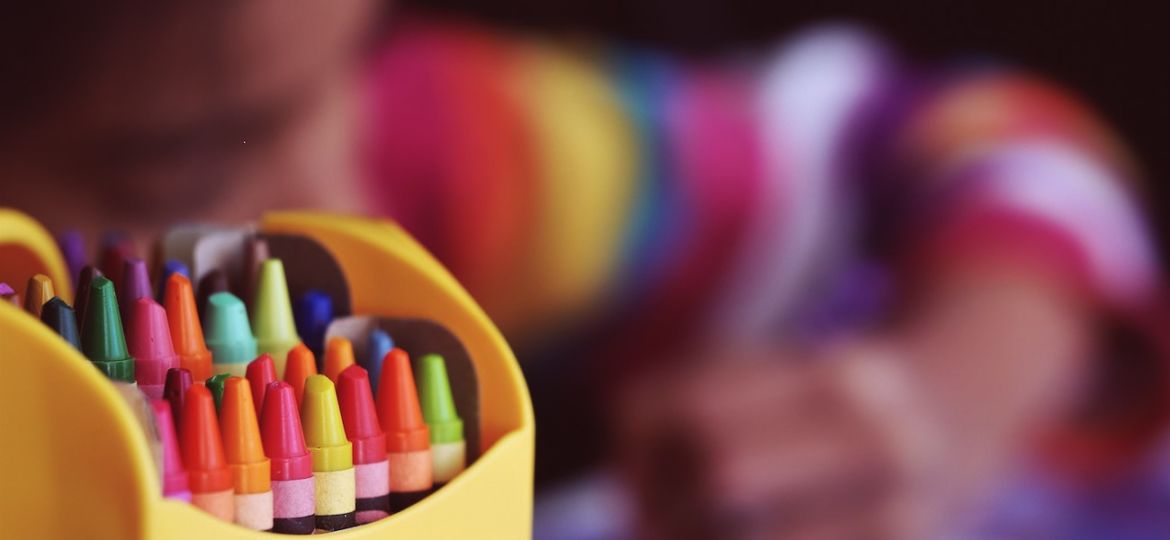 a child coloring with crayons