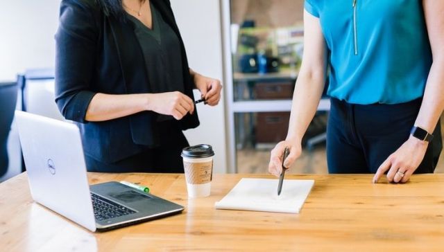 Women working at desk Indy Maven