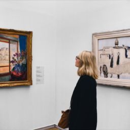 Woman admiring art in gallery_Indy Maven_Unsplash