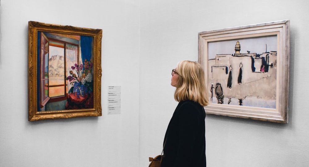 Woman admiring art in gallery_Indy Maven_Unsplash