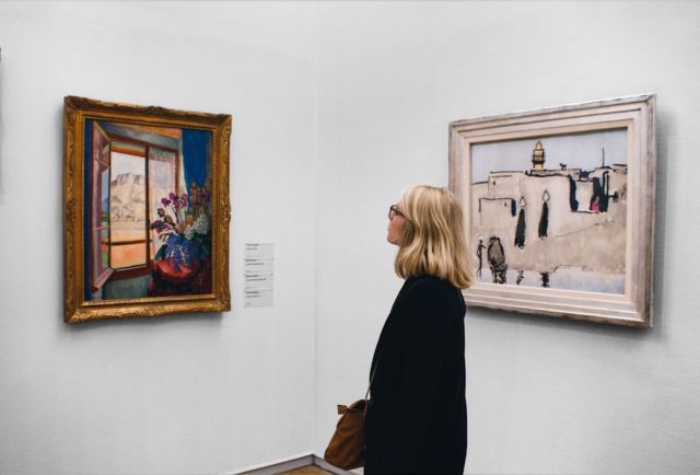 Woman admiring art in gallery_Indy Maven_Unsplash
