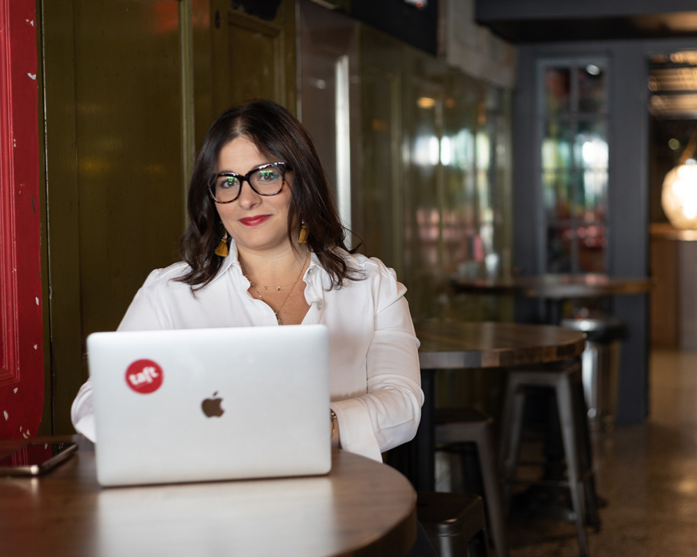 woman typing on a laptop