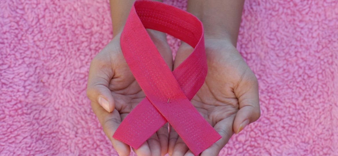 Hands holding pink breast cancer awareness ribbon