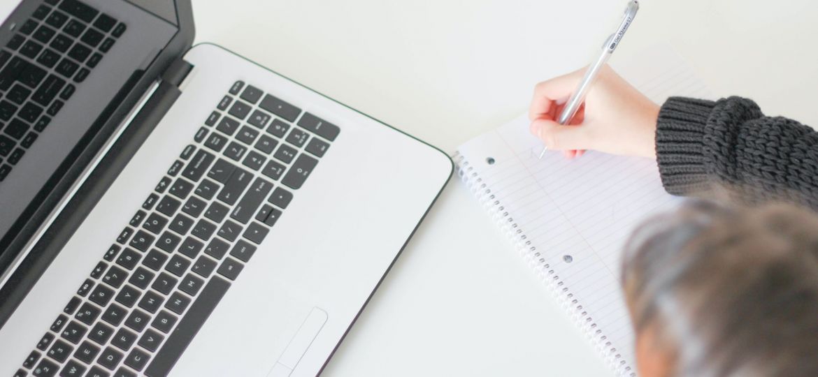Photo from Unsplash depicting a person working at their laptop.