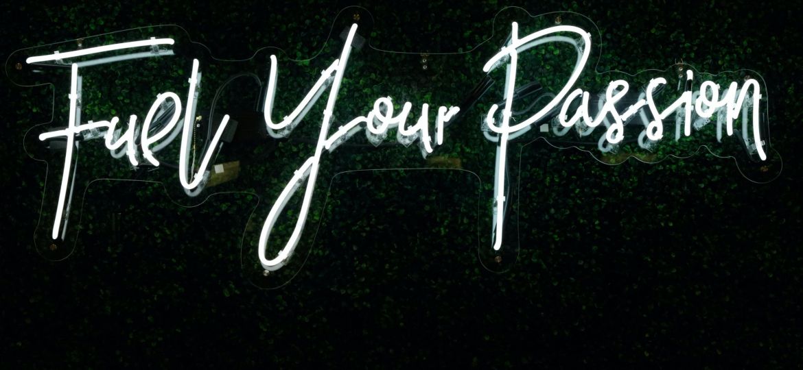 A neon sign reads "Fuel your Passion."