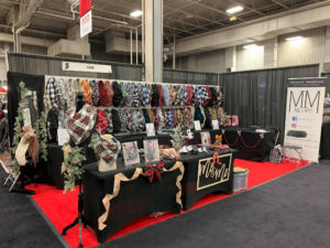 Image of a booth at the Holiday Mart displaying scarves for sale.