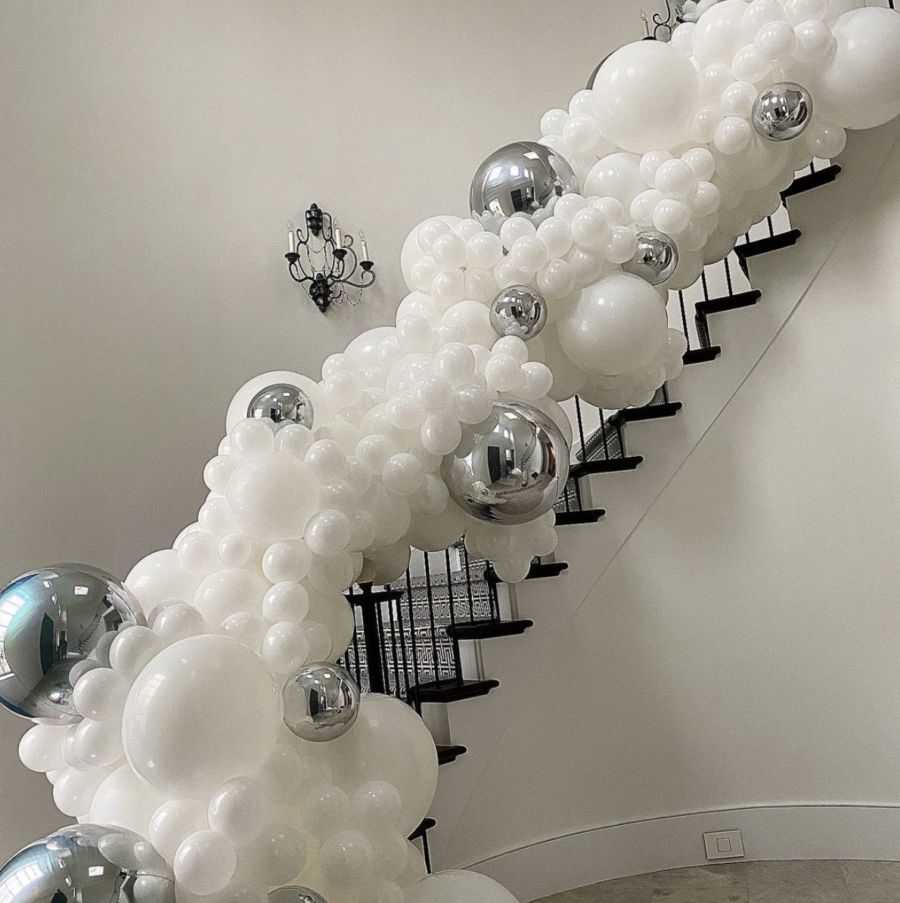 Banzi balloon garland wrapping up a staircase