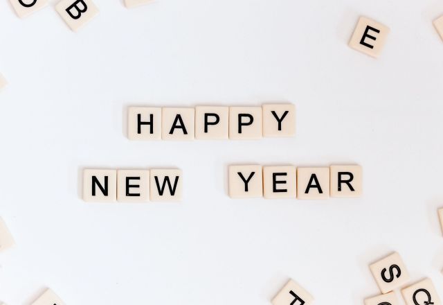 A selection of Scrabble tiles that read "Happy New Year"