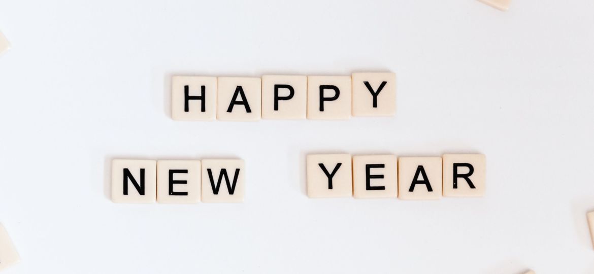 A selection of Scrabble tiles that read "Happy New Year"