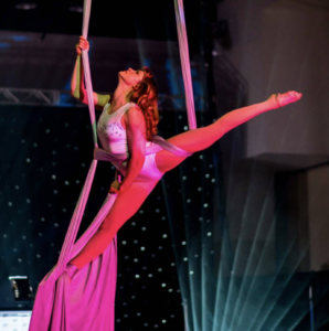 Photo of Cirque Indy's Owner and Instructor Mary on aerial silks