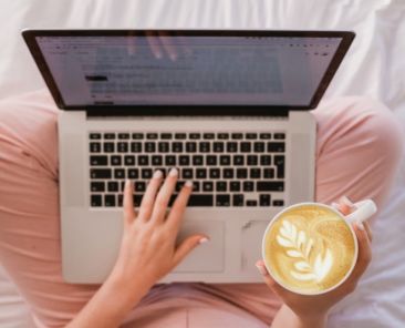 A woman with a latte and a laptop