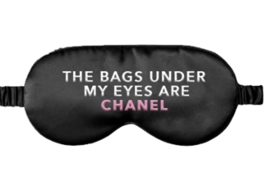 A photo of an eye mask with the words "The Bags Under My Eyes Are Chanel"