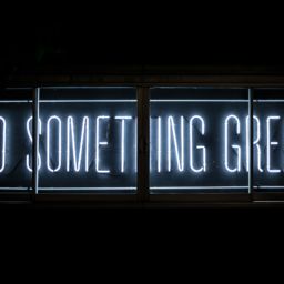 A neon sign that says "Do Something Great"
