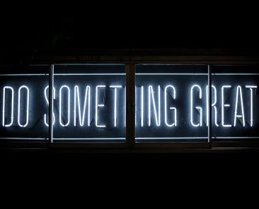 A neon sign that says "Do Something Great"