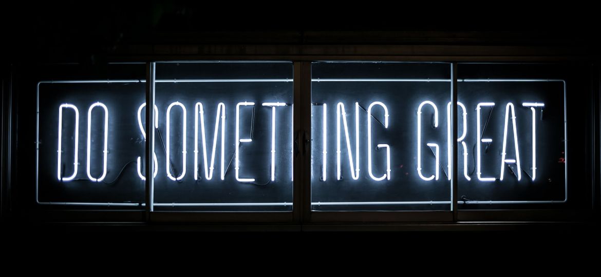 A neon sign that says "Do Something Great"