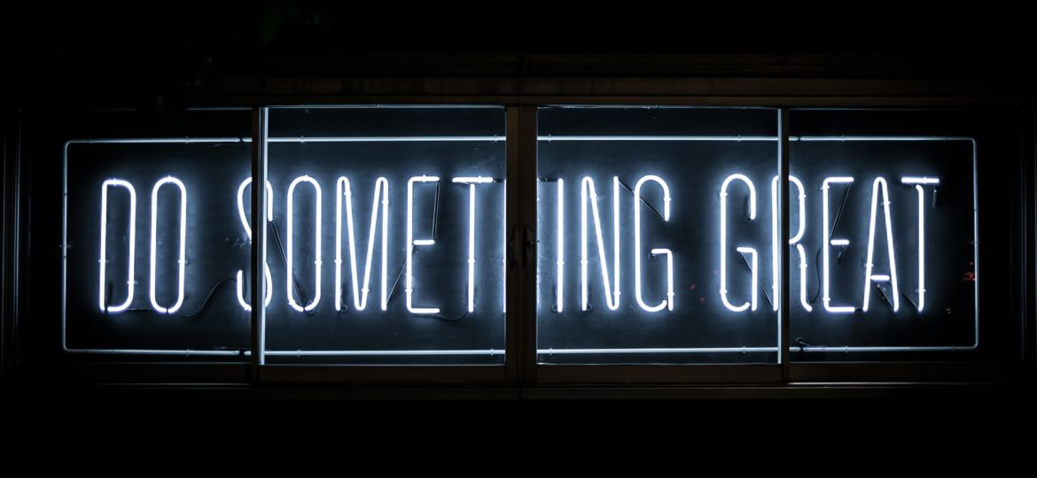 A neon sign that says "Do Something Great"