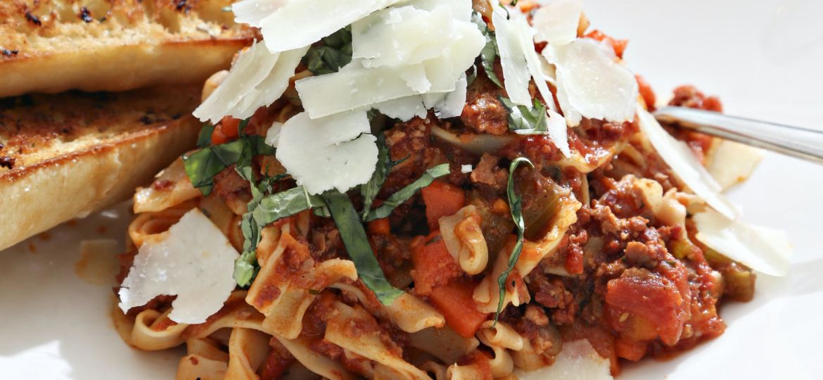 A plate of pasta with bolognese sauce