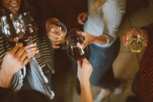 Women toasting wine glasses