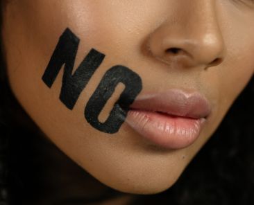 A woman with the word no painted next to her mouth