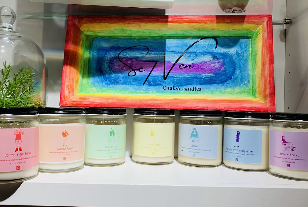 A photo of a collection of candles in rainbow colors