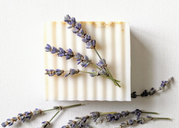 A photo of a white bar of soap with lavender