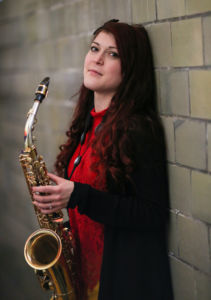 A photo of Amanda Gardier holding a saxophone