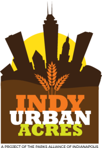 A photo of the Indy Urban Acres logo, with a skyline in the background and a wheat logo