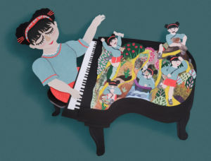 A photo of a paper pianist playing the piano that has artwork on it