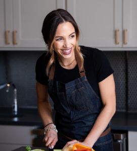 A photo of a woman, Kelsey Murphy, in the kitchen cooking