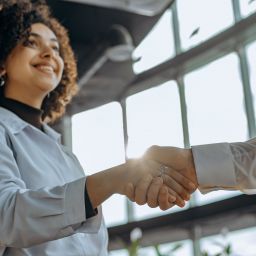A photo of a woman shaking someone's hand