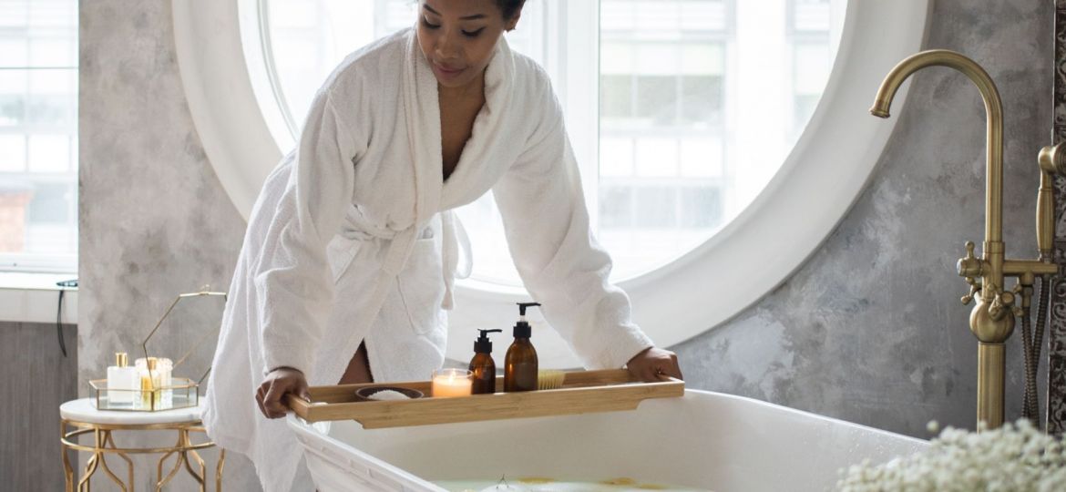 A woman leaning over a bathtub
