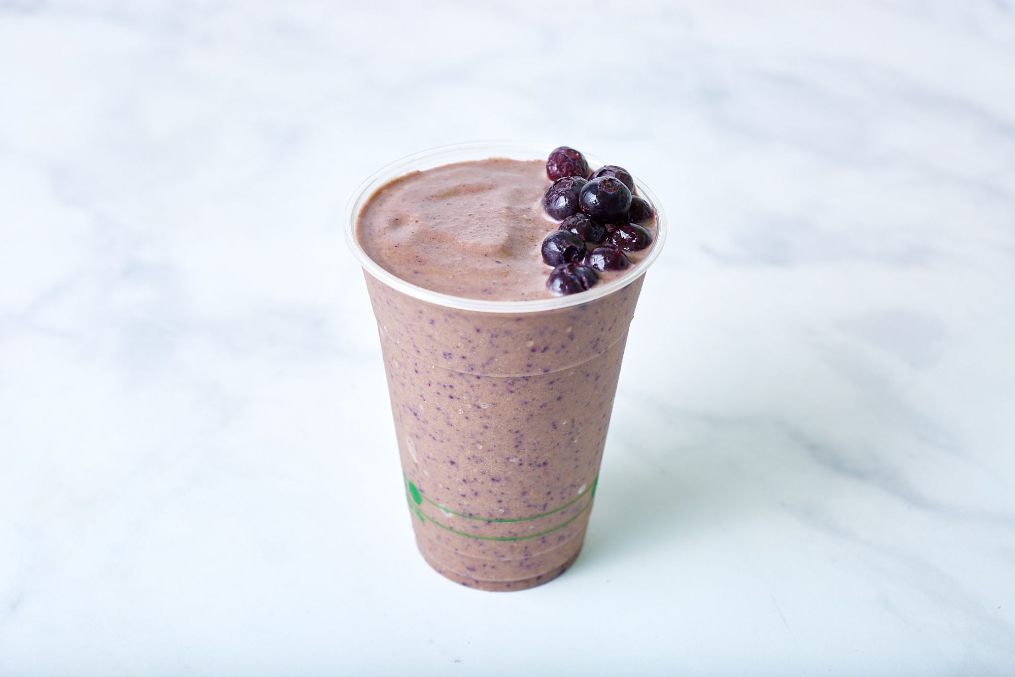 A photo of a purple smoothie with berries on top
