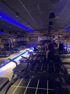 A photo of the inside of Solidcore with blue lights and equipment