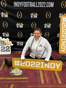 A photo of a woman at Indy Football with a #2022Indy sign 