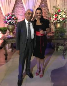 A photo of a woman and her dad in formal clothes