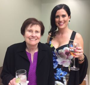 A photo of a woman and her mom holding a wine glass