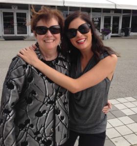 A photo of two women hugging each other wearing sunglasses