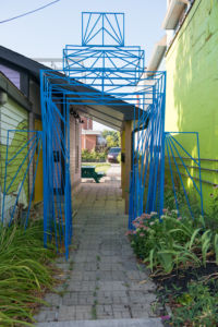 A photo of a large blue structure on a pathway