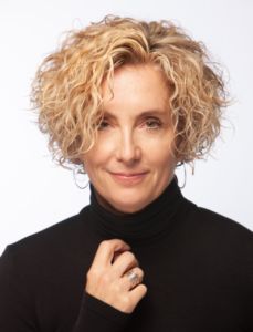 A photo of a woman in a black turtle neck 