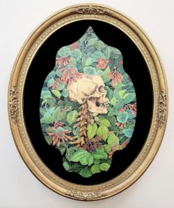 A photo of a frame with a skull artwork inside