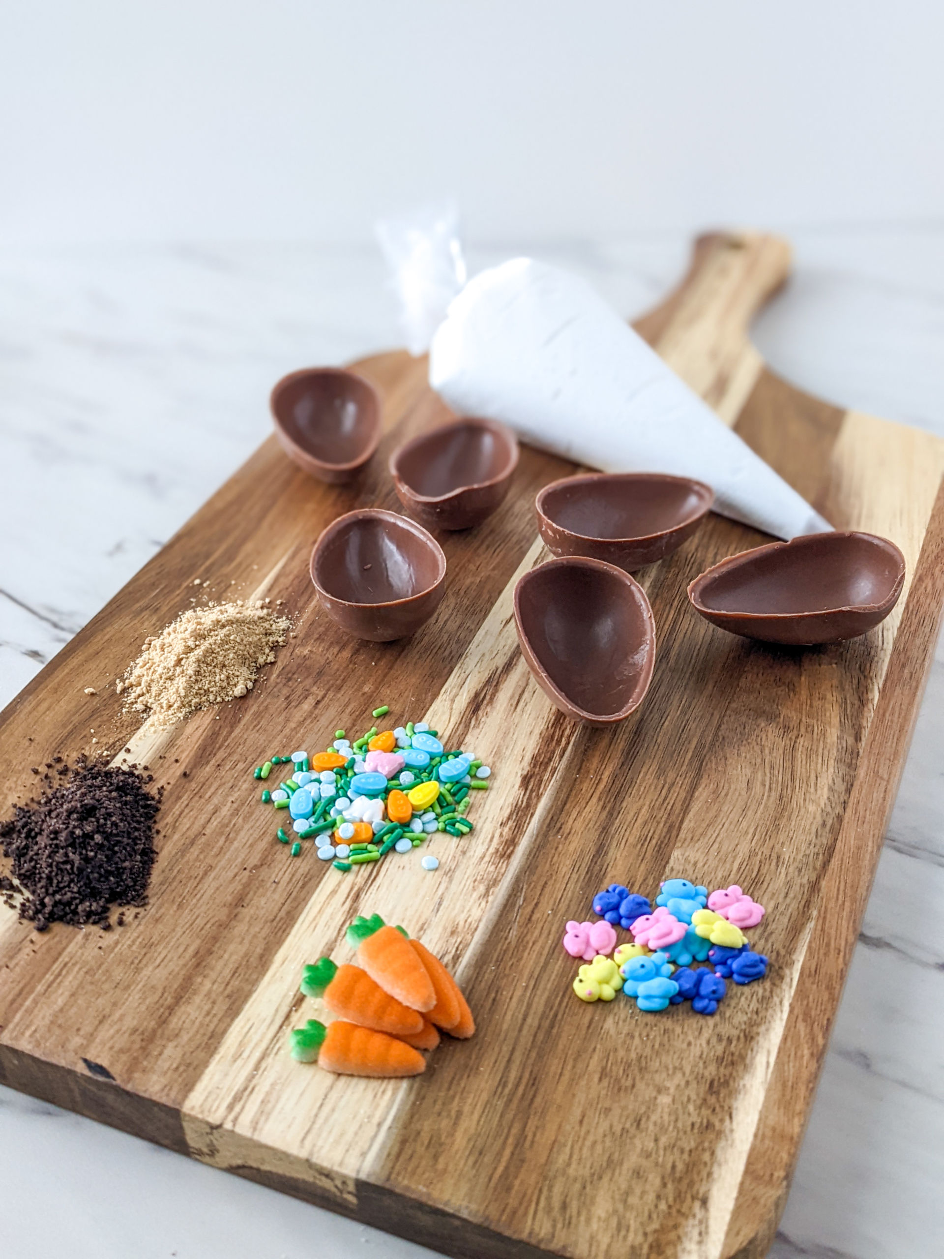 A photo of empty chocolate egg shells and easter sprinkles next to it on a table