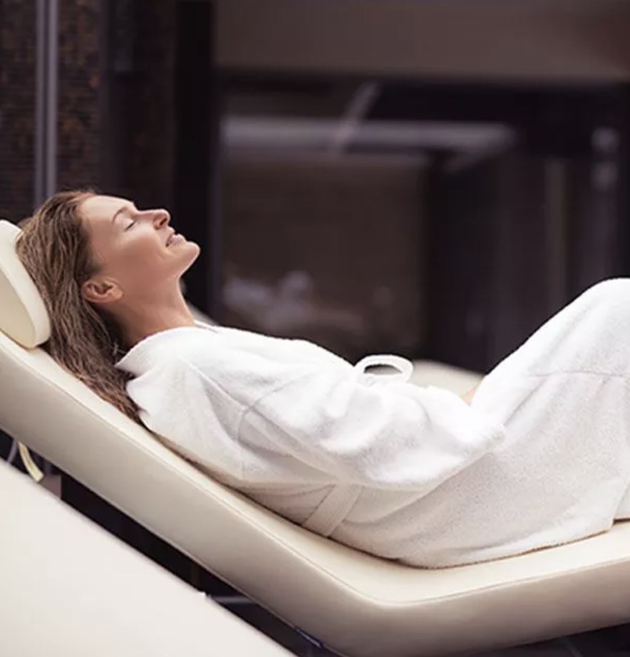 A photo of a woman in a robe relaxing