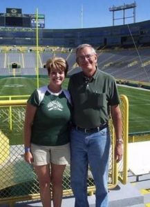 A photo of a woman and her dad at a football stadium