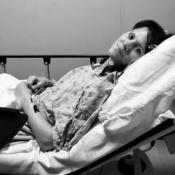 A photo of a woman in a hospital bed