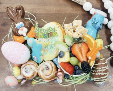 A photo of an Easter basket with assorted foods and sweets