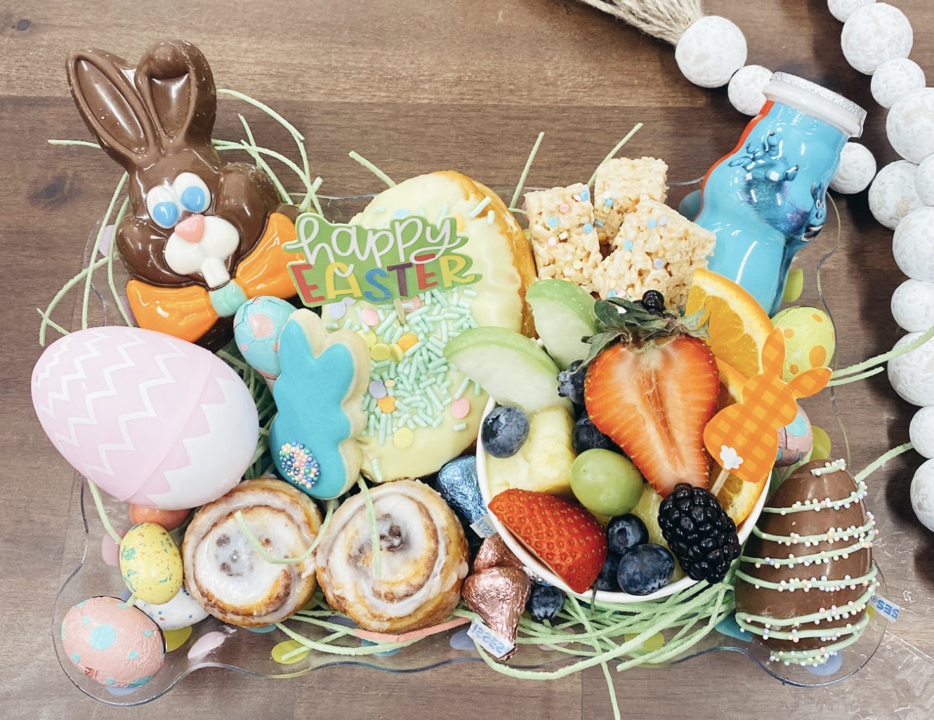 A photo of an Easter basket with assorted foods and sweets