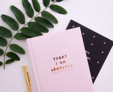 A photo of a journal book that says "Today I Am Grateful"