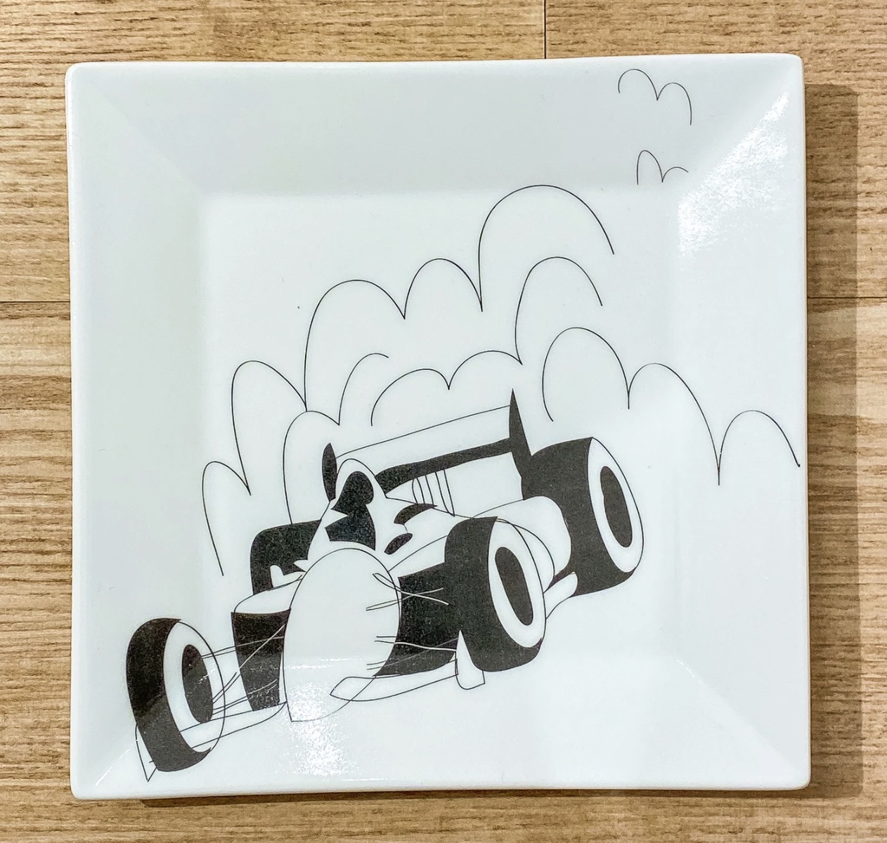 A porcelain plate with a race car printed on it